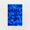An abstract art print featuring layered, flowing ribbon-like forms in various shades of blue against a dark blue striped background, presented with a white border on a light gray background.