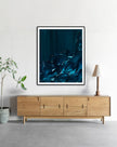 Tranquil Tide by Lara Sayegh displayed in a black frame, an abstract ocean wall art print with expressive blue brushstrokes, printed on museum-quality Giclée Fine Art Paper.