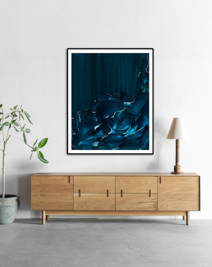 Tranquil Tide by Lara Sayegh displayed in a black frame, an abstract ocean wall art print with expressive blue brushstrokes, printed on museum-quality Giclée Fine Art Paper.